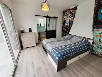 a small bedroom with a bed and a dresser at Appartement Familial proche de Carcassonne in Villemoustaussou