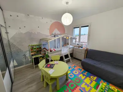 a living room with a couch and a table at Appartement Familial proche de Carcassonne in Villemoustaussou