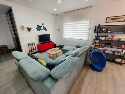 a living room with a couch and a tv at Appartement Familial proche de Carcassonne in Villemoustaussou