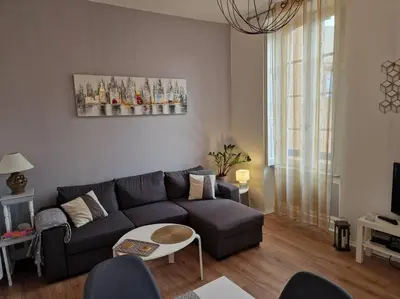 a living room with a couch and a table at Appartement cosy hypercentre in Narbonne