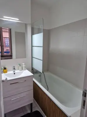 a bathroom with a tub and a sink and a shower at Appartement cosy hypercentre in Narbonne
