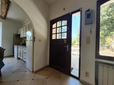 a kitchen with a black door and a window at La Roche 6 in Aigues-Vives