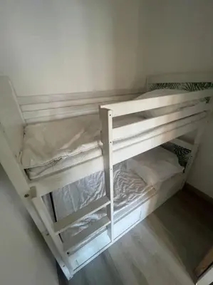 two white bunk beds in a room at Palma Studio bis 4 pers - 100m plage in Port-la-Nouvelle