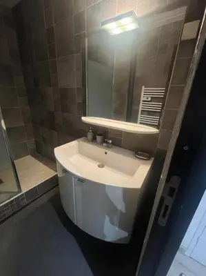 a bathroom with a white sink and a mirror at Palma Studio bis 4 pers - 100m plage in Port-la-Nouvelle