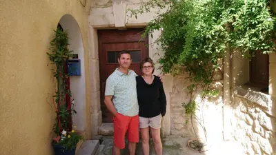 a man and a woman standing in front of a building at La Félicita - Gîte de charme proche de Narbonne in Moussan