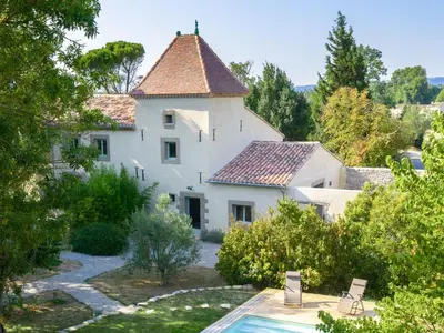 a large white house with a tile roof at Domaine des Périès - Chambres d'hôtes in Saint-Martin-Lalande