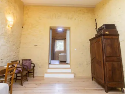 a room with a staircase and a wooden cabinet at Domaine des Périès - Chambres d'hôtes in Saint-Martin-Lalande