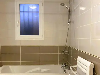 a bathroom with a bath tub and a window at Lily in Escales