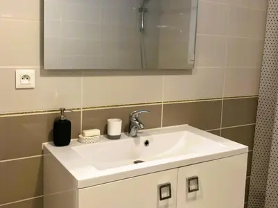 a bathroom with a white sink and a mirror at Lily in Escales