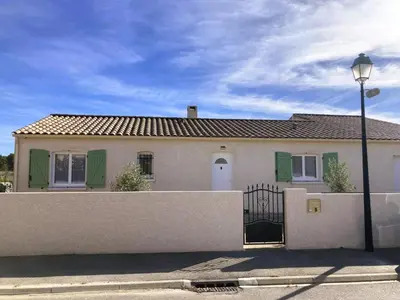 a white house with a fence and a street light at Lily in Escales