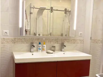 a bathroom with a white sink and a mirror at Lily in Escales
