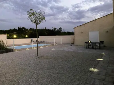 a courtyard with a table and a tree next to a building at Lily in Escales