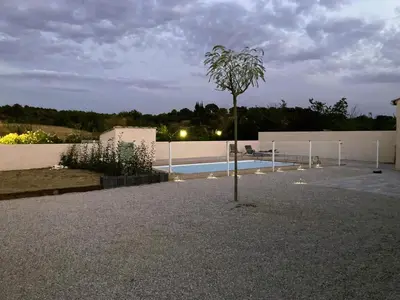 a tree in the middle of a courtyard with a pool at Lily in Escales