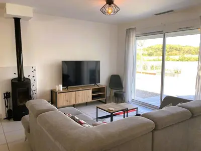 a living room with a couch and a flat screen tv at Lily in Escales