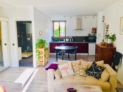 a living room with a couch and a kitchen at Anna's gîte in Lagrasse