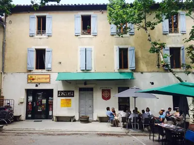 a group of people sitting outside of a building at Anna's gîte in Lagrasse