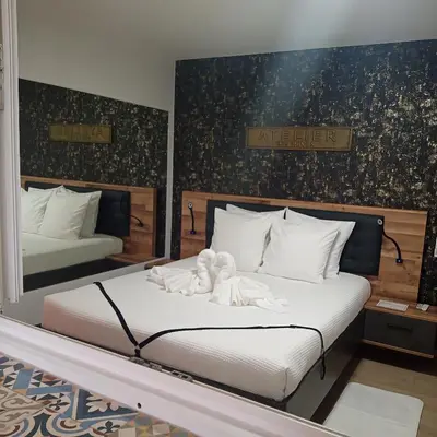 a bedroom with a bed with two angels on it at Love Room Emoi de toi in Sigean
