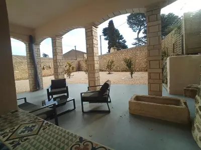 a living room with two chairs and a couch at Love Room Emoi de toi in Sigean