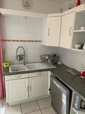 a kitchen with white cabinets and a sink at les amandiers in Salses-le-Chateau