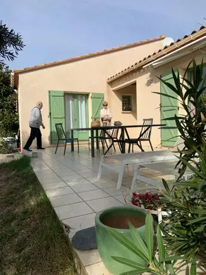 two people walking on the patio of a house at les amandiers in Salses-le-Chateau