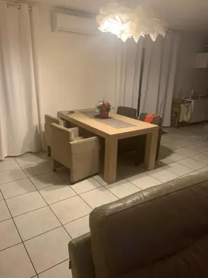 a table and chairs in a living room at les amandiers in Salses-le-Chateau