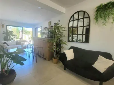 a living room with a couch and a table at Les Amandiers in Sallèles-dʼAude