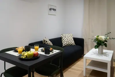a living room with a table with a plate of fruit at La Villa Orange - Proche cité médiévale et centre ville à pied in Carcassonne