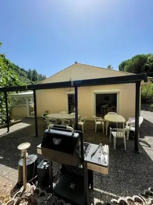 a bedroom with a bed and a chair and a window at Maison calme en pleine nature jusqu'à 10 personnes in Cabrespine