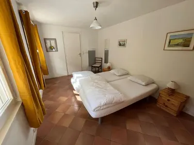 a room with a bed and two windows at Maison calme en pleine nature jusqu'à 10 personnes in Cabrespine