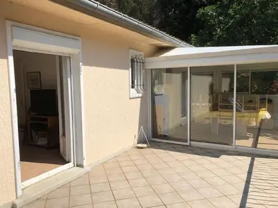 a white kitchen with a microwave and a refrigerator at Maison calme en pleine nature jusqu'à 10 personnes in Cabrespine