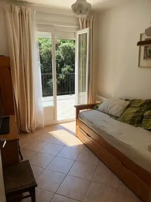 a living room with a bed and a television at Maison calme en pleine nature jusqu'à 10 personnes in Cabrespine