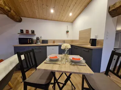 a kitchen with a table with two bowls on it at Refuge Insolite avec balnéo privative en forêt in Pont-de-Larn