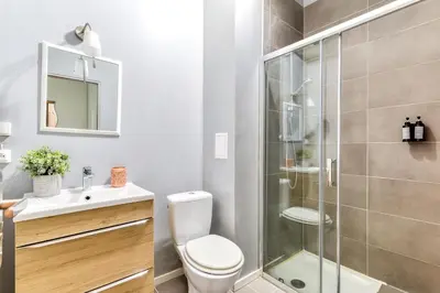 a bathroom with a shower and a toilet and a sink at El Quatro - Wifi - Central - tout équipé in Carcassonne