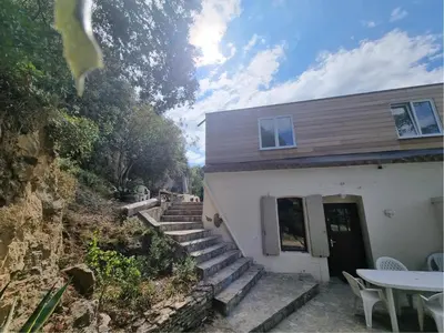 a house with stairs leading up to a building at La Roche 8 in Aigues-Vives