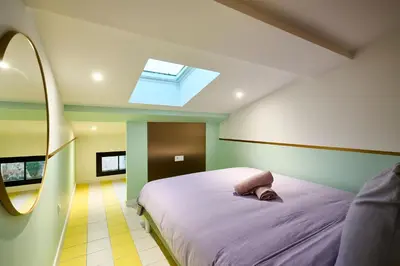 a bedroom with a bed and a skylight at La Villa Orange - Instagood - proche cité médiévale et centre ville à pied in Carcassonne