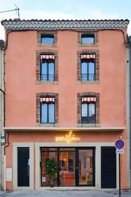 an orange brick building with a store window at La Villa Orange - Instagood - proche cité médiévale et centre ville à pied in Carcassonne