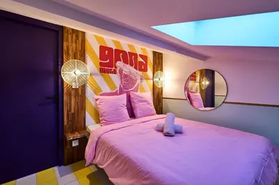 a bedroom with a large pink bed with a mirror at La Villa Orange - Instagood - proche cité médiévale et centre ville à pied in Carcassonne