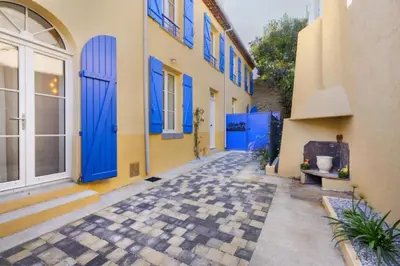 an alley with blue doors in a building at L'Impasse d'Adam Free Parking in Carcassonne