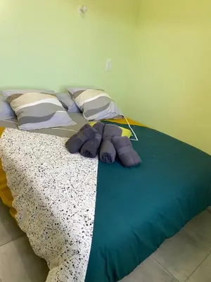 a bed with purple blankets and pillows on it at T3 Gîte le Canigou in Trévillach