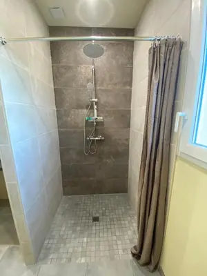 a bathroom with a shower with a shower curtain at T3 Gîte le Canigou in Trévillach