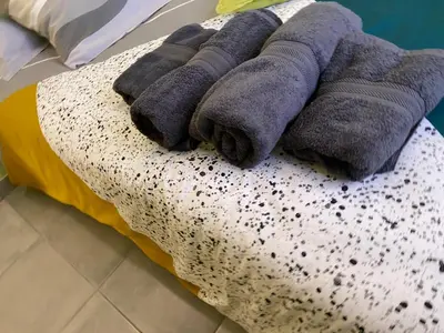 a pile of towels sitting on top of a bed at T3 Gîte le Canigou in Trévillach