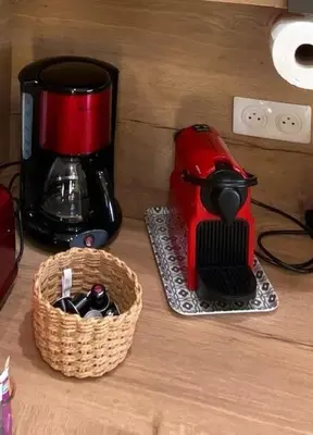 a red coffee maker and a basket on a counter at T3 Gîte le Canigou in Trévillach