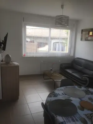 a living room with a couch and a window at Chez Domi in Trèbes