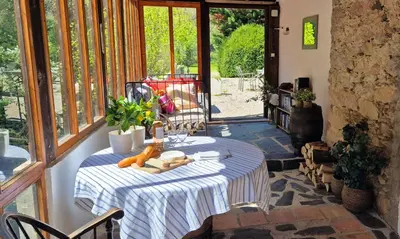 a room with a table with carrots on it at Au Pont Romain Gites in Caunes-Minervois