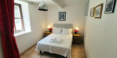 a bedroom with a bed with two towels on it at Au Pont Romain Gites in Caunes-Minervois