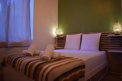 a bedroom with a bed with towels on it at La République d'Emmanuel in Carcassonne