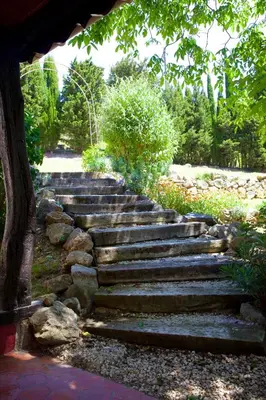 a set of stone stairs in a garden at Moulin de Perle in Fosse