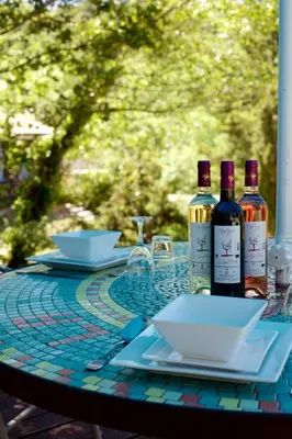 a table with two bottles of wine on a table at Moulin de Perle in Fosse