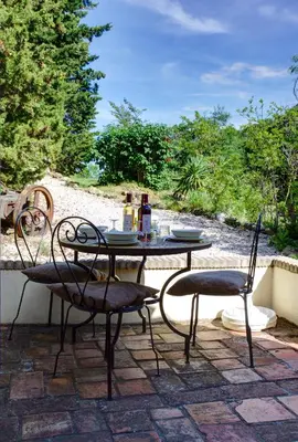 a table and chairs sitting on a patio at Moulin de Perle in Fosse