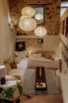 a living room with white couches and a fireplace at Pausette in Fanjeaux